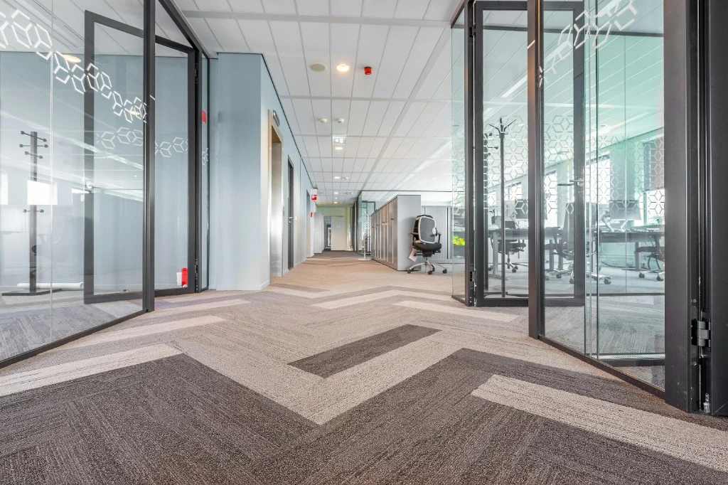 Commercial office carpet with geometric pattern after maintenance cleaning